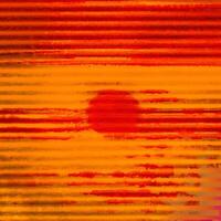 Vibrant abstract background with textured red and orange horizontal stripes resembling a grunge pattern. photo