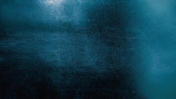 Dark teal textured surface with soft gradients and rough details, ideal for backgrounds or creative overlays. photo