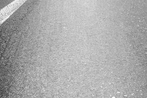 Smooth gray asphalt road surface texture with subtle grain, ideal for backgrounds, designs, or urban concepts. photo