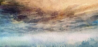 Abstract watercolor painting of a dramatic sky blending warm orange hues with cool blue and gray tones. photo