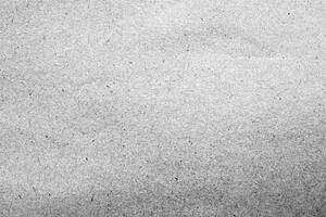 Close-up of a gray recycled paper texture with a rough surface and visible fibers, perfect for design projects. photo