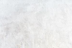 Light white textured wall with subtle patterns and brush strokes, ideal for minimalist backgrounds or design projects. photo