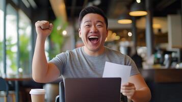asian man sitting at a table in a cafe or restaurant. photo