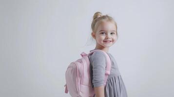 portrait of a young girl, probably around 6-7 years old, standing against a white background photo
