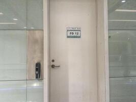 Jeddah, Saudi Arabia on 22 February 2024. White Door Access Security System Keypad Modern Office Building photo