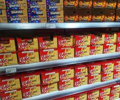 Madinah, Saudi Arabia on 28 February 2024. KitKat White Chocolate Bars Supermarket Shelf Display Colorful Packaging photo