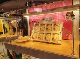 Tokyo, Japan on 08 October 2023. Strawberry Mochi Cakes Display Sweet Treats Pink Background Showcase photo