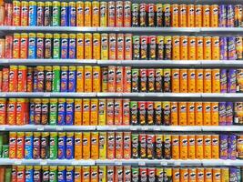 Madinah, Saudi Arabia on 28 February 2024. Colorful Pringles and Other Chip Cans Grocery Store Shelf Display photo