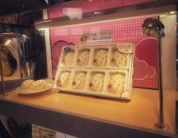 Tokyo, Japan on 08 October 2023. Strawberry Mochi Cakes Displayed Pink Packaging Sweet Shop photo
