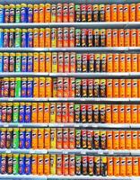Madinah, Saudi Arabia on 28 February 2024. Colorful Pringles Cans Stacked Shelves Grocery Store Display photo