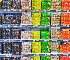 Madinah, Saudi Arabia on 28 February 2024. Colorful Mini Cans Pepsi Seven Up Displayed On Shelves Supermarket Store photo