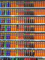 Madinah, Saudi Arabia on 28 February 2024. Colorful Pringles Potato Chips Cans Displayed On Shelves Grocery Store photo