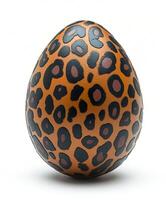 A decorated egg with a leopard print design on a white background. For Easter egg photo