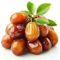 Fresh, ripe dates piled together with green leaves on display. photo