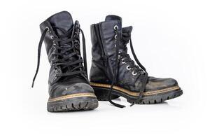 Pair of rugged worn black ankle leather combat boots with thick, sturdy soles and laces. Two vintage military style shoes. Studio light. Isolated on white background. Copy space. Clipping path 2 photo