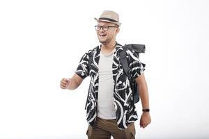 Happy young Asian man wearing a straw hat and backpack doing a walking or strolling gesture. photo