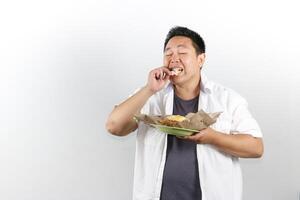Man Enjoying Delicious Indonesian Fried Rice with crackers photo