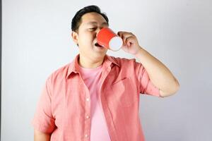 Man Enjoying a Drink from a red cup photo