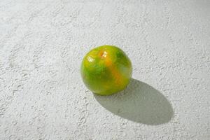 a single green orange isolated on white texture background photo