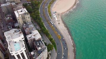 Aerial view of coastal highway and beachfront, Scenic aerial shot of a highway along the coast, adjacent to a beach and urban buildings. Downtown Chicago. video