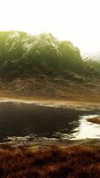 Plain with dried grass and mountain peaks in the background video