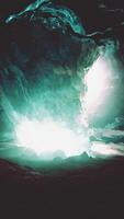 blue ice cave covered with snow and flooded with light video