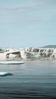 gigantic Ice block structures on the black sand by the sea shore video