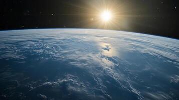 The sun is shining on the blue planet Earth. The sky is clear and the sun is bright photo