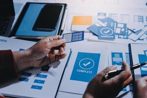A person is working on a project with blue and white papers photo
