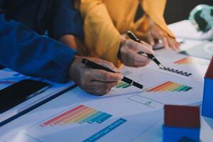 Business people working on a project with graphs and charts photo