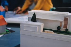 A model of a house is on a table photo