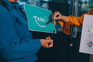 Two people holding up a sign with the words esg photo