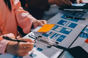A person is working on a laptop with a piece of paper photo