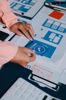 A person is working on a computer with a blue button photo