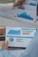 A group of people looking at graphs and charts photo