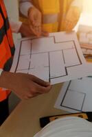 A group of people are working on a blueprint photo