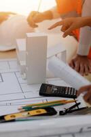 A group of people working on a blueprint photo