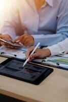 A person using a tablet computer at a desk photo