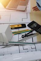 A person working on a laptop and a calculator photo