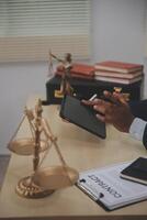 A person in a suit is using a tablet on a desk photo