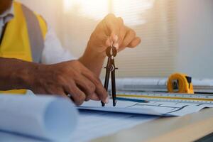 A man in a yellow vest is holding a pair of scissors photo