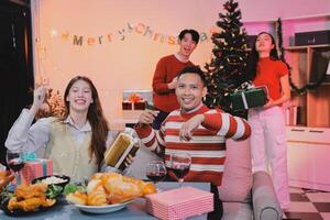 A group of people sitting around a table with christmas decorations photo
