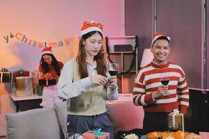 A man and woman standing in front of a table with a christmas tree photo