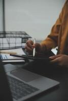 A person using a pen to write on a tablet photo
