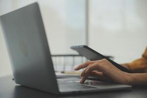 A person using a laptop and tablet computer photo