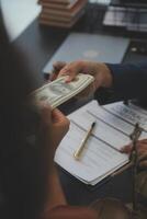 A man is counting money in a business meeting photo