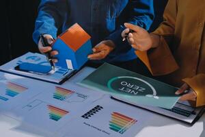 Two people are holding a piece of paper with a graph on it photo
