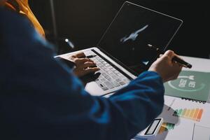 A person typing on a laptop computer photo