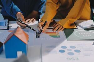 Business people working on a project with graphs and papers photo
