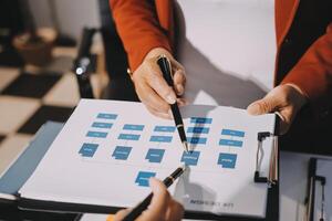 A person holding a pen and paper with a diagram on it photo